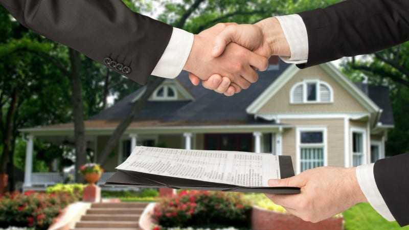 People shaking hands in a real estate transaction